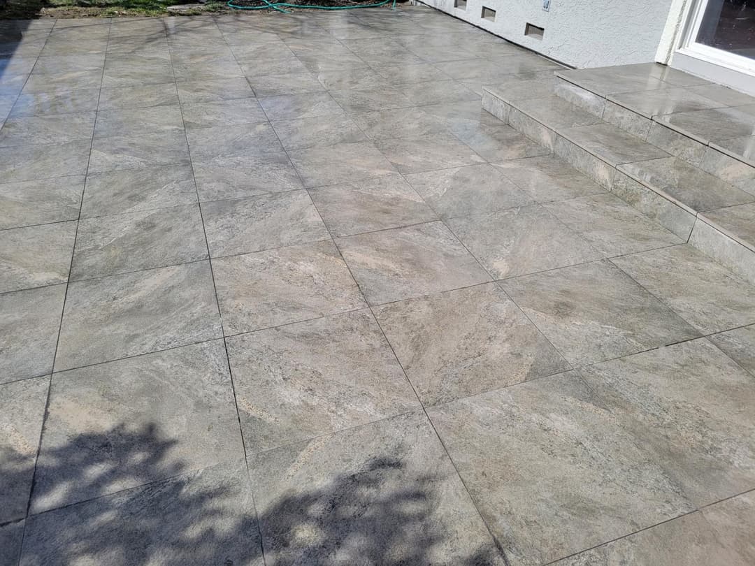 picture of a newly installed paver backyard patio with textured pavers